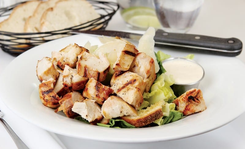 Chicken Caesar Salad in White Bowl with Dressing on Side Food Picture