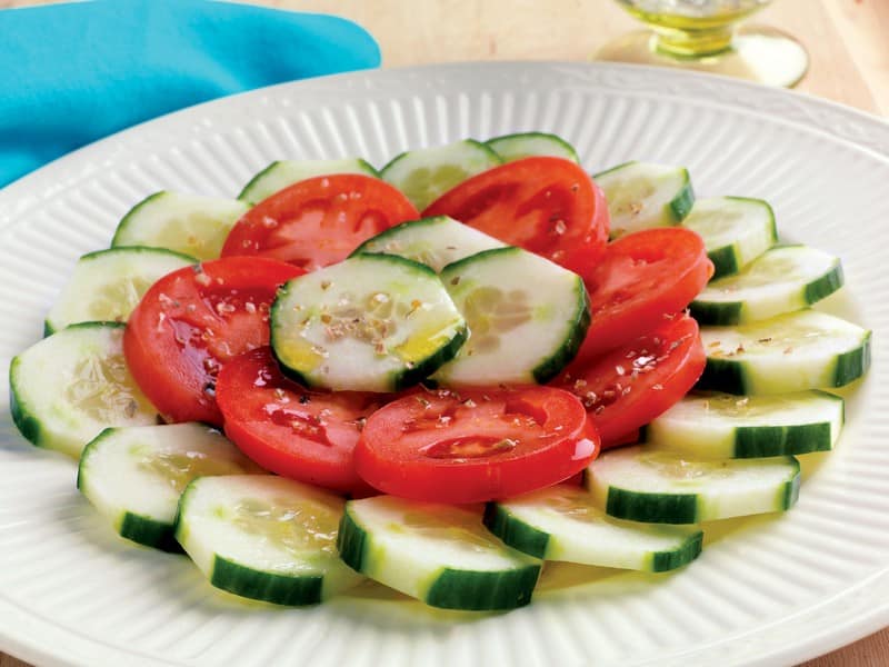 Tomato and Cucumber Salad on White Ridged Plate Food Picture