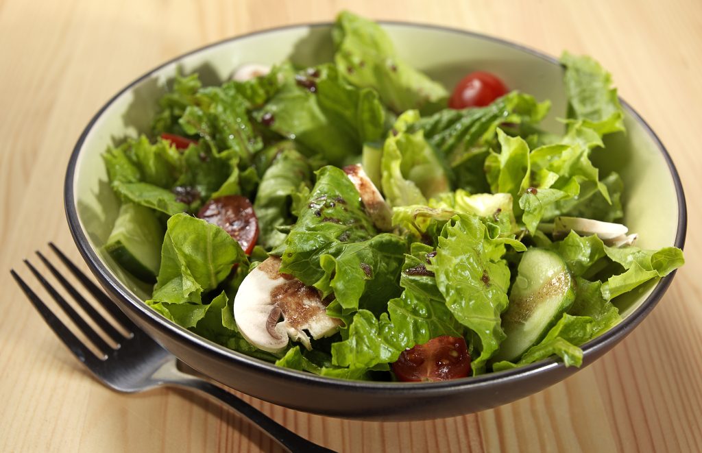 Tossed Romaine Salad in Bowl on Table Food Picture