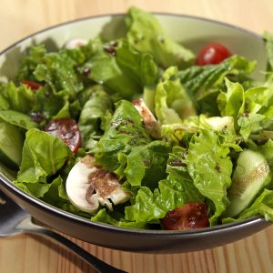 Tossed Romaine Salad in Bowl on Table Food Picture