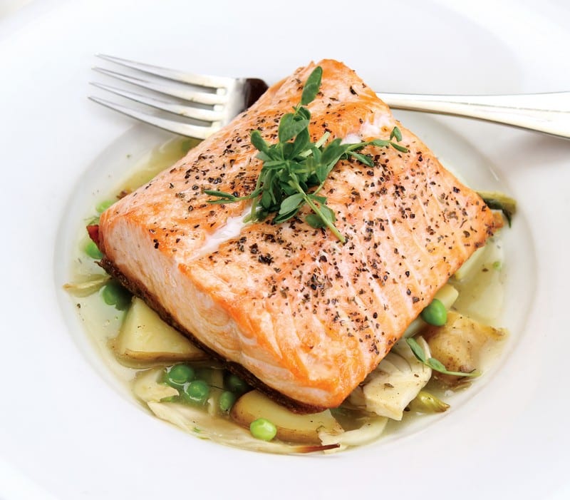 Salmon Fillet in Veggie Soup Broth with Garnish Food Picture