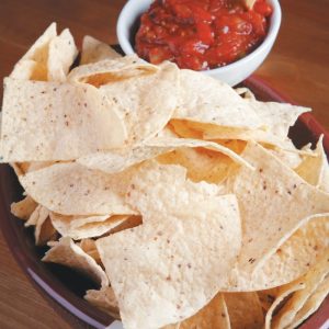 Chips and Salsa in Football Bowl on Wooden Surface Food Picture