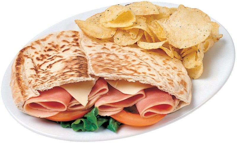 Pita Bread Sandwich with Side of Chips on White Plate Food Picture
