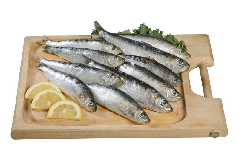 Whole Sardines on Cutting Board with Lemons Food Picture