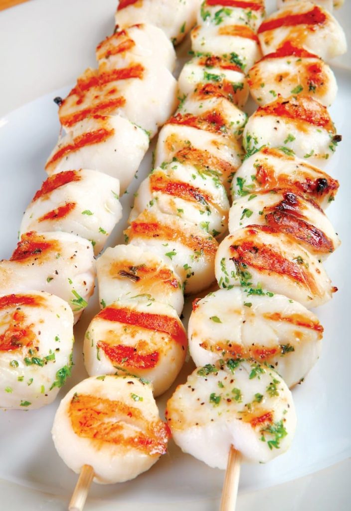 Scallops on Skewers with Seasoning on White Plate Food Picture
