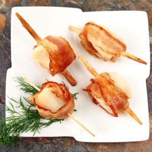Bacon-Wrapped Scallops on Modern White Ceramic Plate with Fresh Dill Sprigs Food Picture