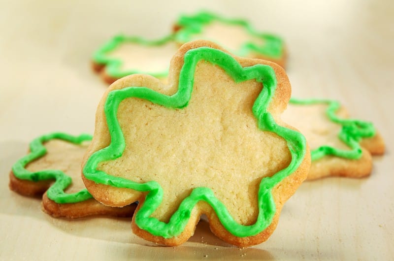 Shamrock Shaped Cookies with Green Icing on Table Food Picture