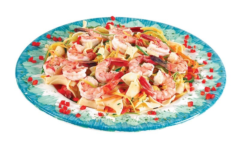 Shrimp over Pasta and Veggies on Blue and White Plate Food Picture