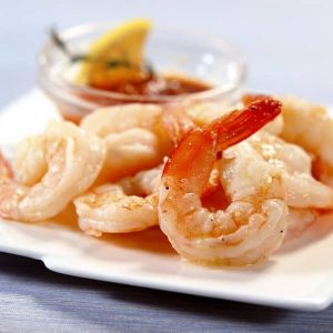 Fresh-Peeled Shrimp on Modern White Plate with Cocktail Sauce and Lemon Food Picture