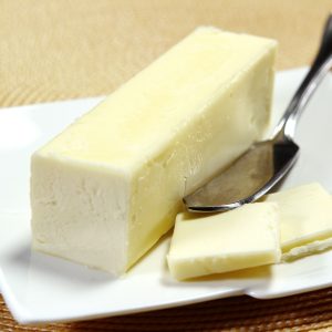 Fresh Margarine Butter Quarter on Modern White Plate with Butter Knife Food Picture