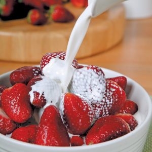 Single Strawberry in Cream in Bowl with Garnish Food Picture