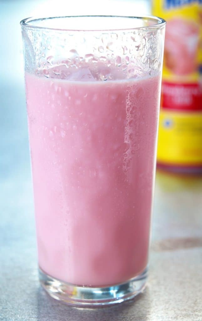 Strawberry Milk in Tall Glass on Aluminum Countertop Food Picture