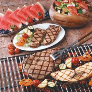 Surf and Turf on Grill and Cement with Salad and Watermelon Food Picture