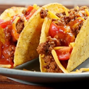 Pair of Hardshell Tacos with Ground Beef, Shredded Cheese, Tomatoes and Salsa on Pale Blue Plate Food Picture