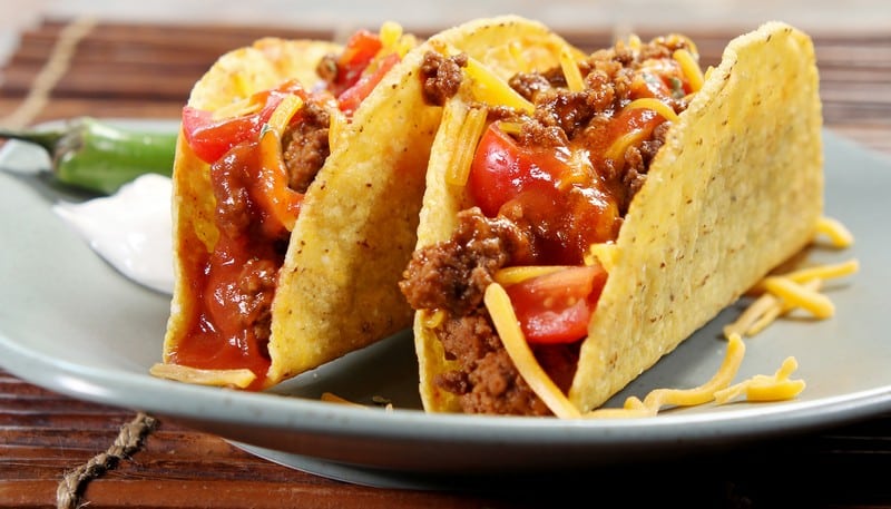 Pair of Hardshell Tacos with Ground Beef, Shredded Cheese, Tomatoes and Salsa on Pale Blue Plate Food Picture