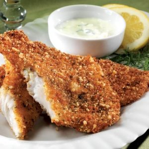 Breaded tilapia with sauce and garnish on white plate Food Picture