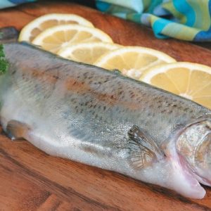 Whole Trout on Cutting Board with Lemons Food Picture
