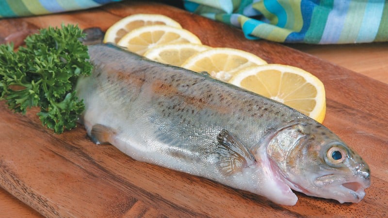 Whole Trout on Cutting Board with Lemons Food Picture