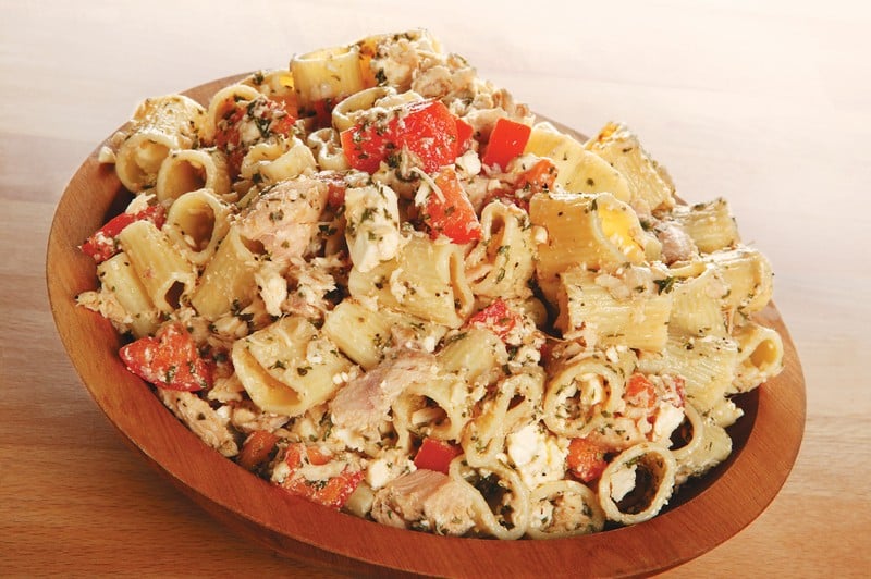 Tuna pasta salad in wooden bowl with tomatoes and seasoning Food Picture