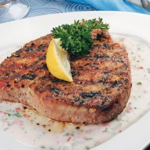 Tuna Steak with garnish and sauce on white plate Food Picture