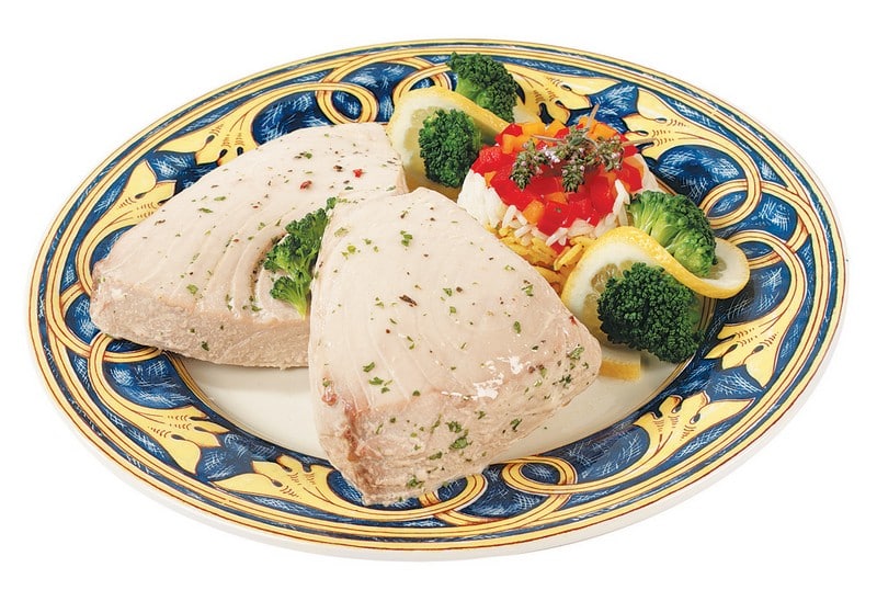 Tuna steak with garnish on yellow and blue plate with white background Food Picture