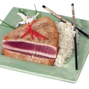 Tuna steak with rice and chopsticks on green plate Food Picture
