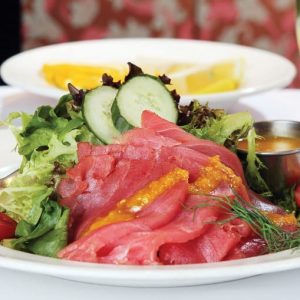 Yellowfin tuna with salad and dressing on white plate with lemon water Food Picture