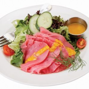 Yellowfin tuna with salad and dressing on white plate with white background Food Picture