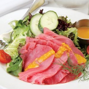 Yellowfin tuna with salad and dressing on white plate Food Picture
