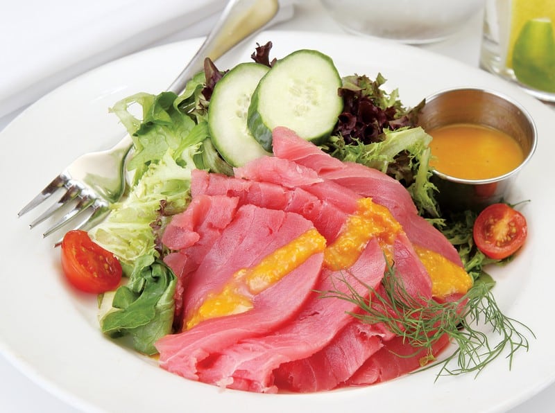 Yellowfin tuna with salad and dressing on white plate Food Picture