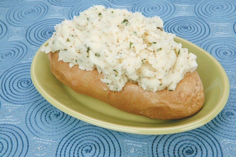 Twice Baked Potatoes on Green Dish on Blue Surface Food Picture