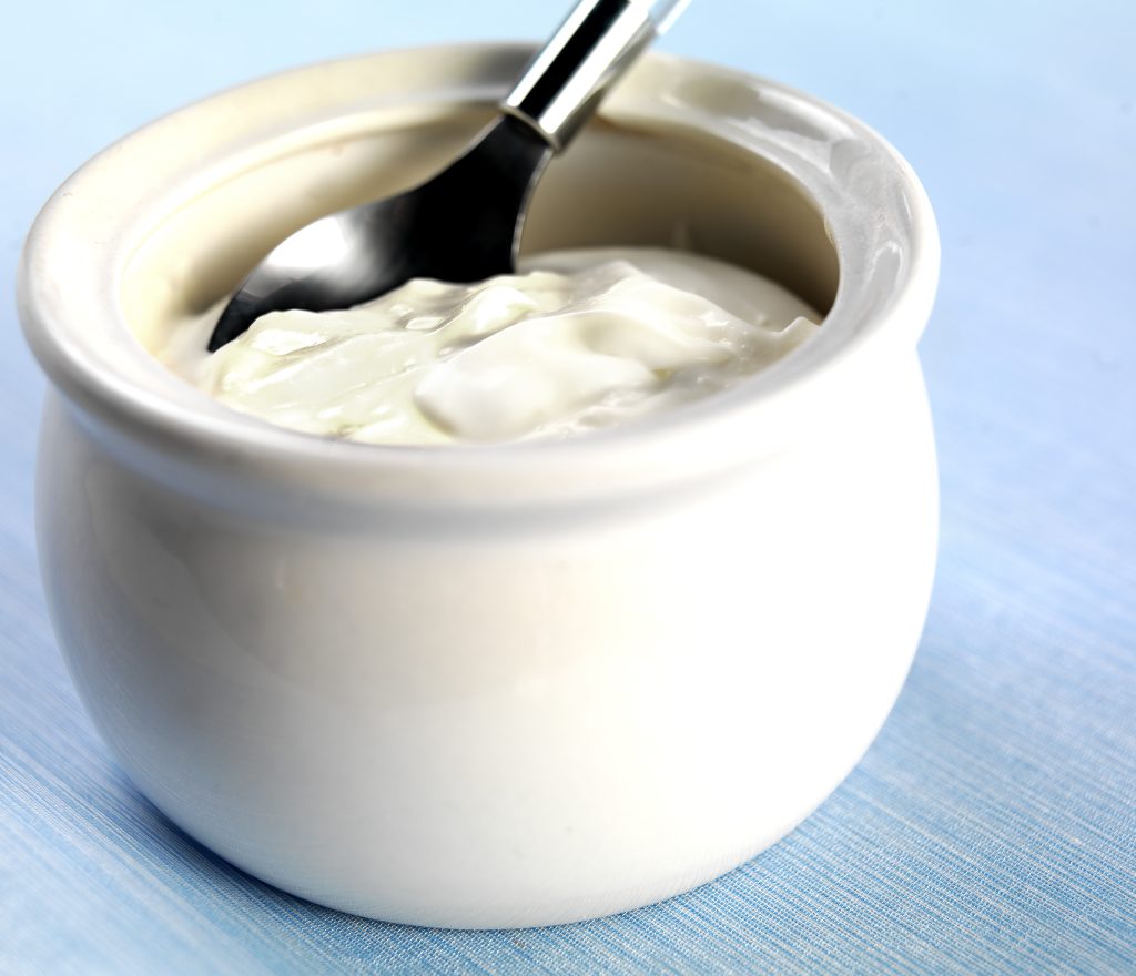 Creme Fraiche Sour Cream in a White Honeypot on a Blue Tablecloth Food Picture