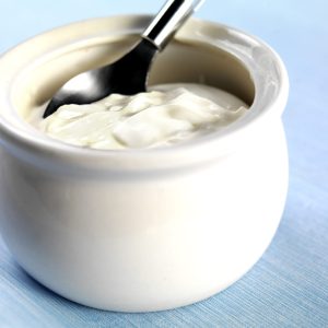 Creme Fraiche Sour Cream in a White Honeypot on a Blue Tablecloth Food Picture